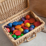 Grapat Loose Parts Rainbow Rounds Set placed in a basket hamper. 