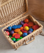 Grapat Loose Parts Rainbow Rounds Set placed in a basket hamper. 