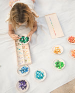 includes a wooden storage board with colourful dots