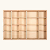 An empty Grapat wooden tinker tray showing different sized compartments for loose pieces