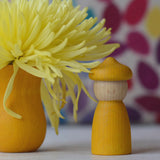 A Spring inspired display using a yellow handcrafted Grapat peg doll with matching hat and cup from the 7 moons calendar set