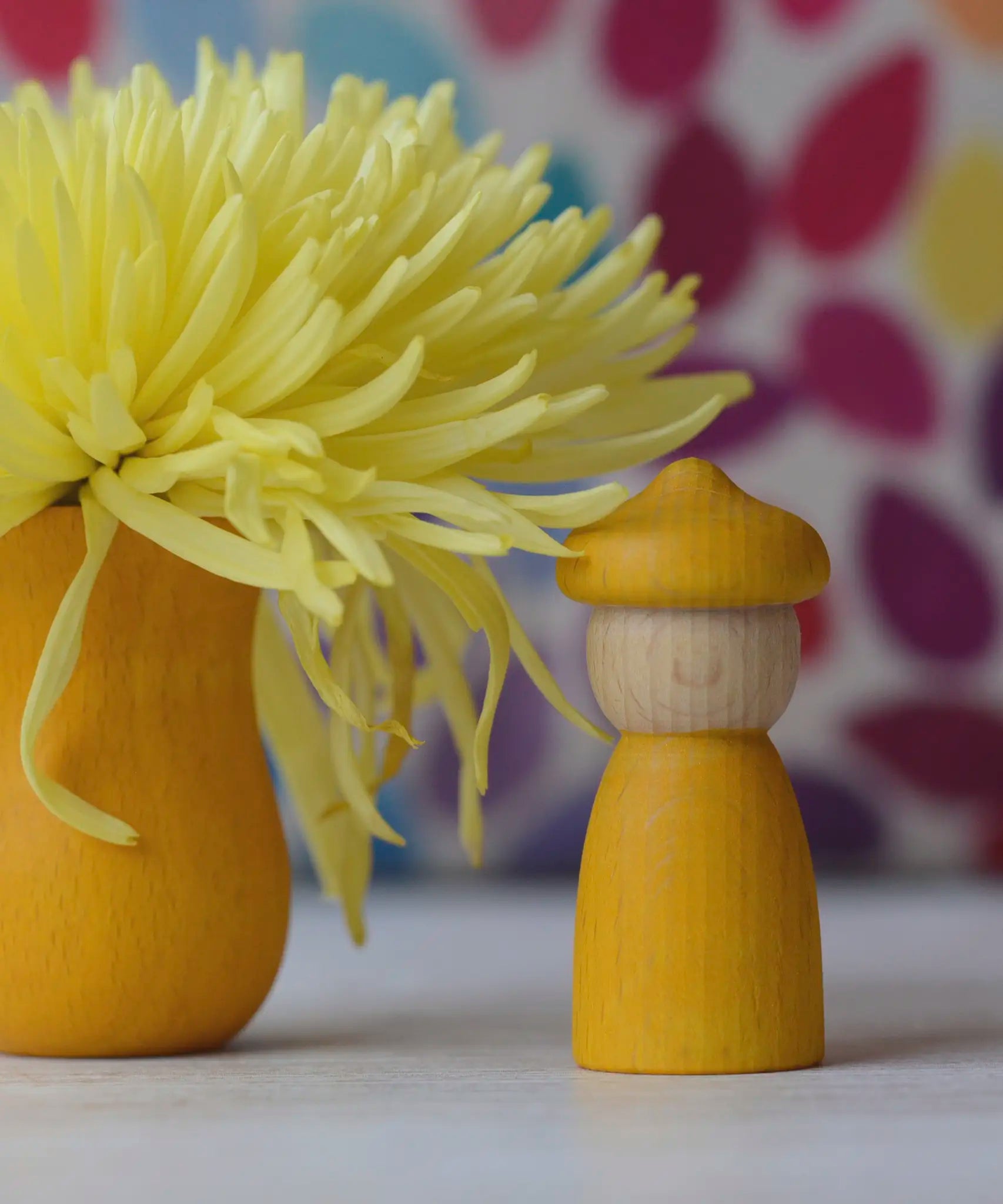 A Spring inspired display using a yellow handcrafted Grapat peg doll with matching hat and cup from the 7 moons calendar set