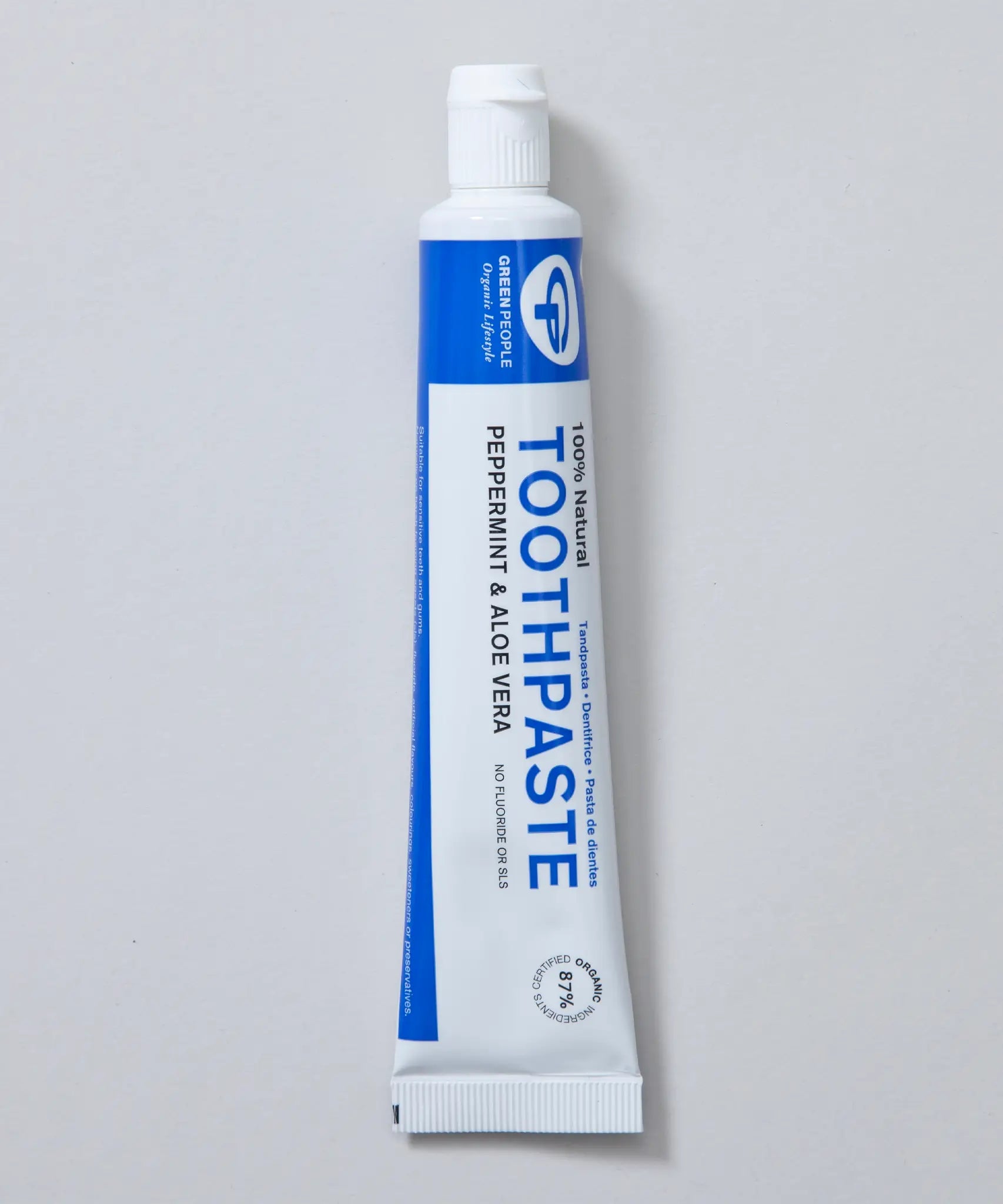 White and blue branded tube of Green People peppermint and aloe vera toothpaste