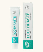Organic People minty cool toothpaste showing the white and green branded tube next to a matching box