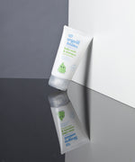 A tube of Organic Babies Baby Wash & Shampoo Scent Free placed on a mirrored surface. 