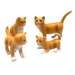 Green Rubber Toys children's small toy cat family on a white background