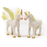 Green Rubber Toys natural rubber golden unicorn and pegasus toys stood on a white background