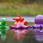 Green Rubber Toys Sea Friends Bath Toy Set pictured in a puddle