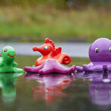 Green Rubber Toys Sea Friends Bath Toy Set pictured in a puddle