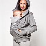  whilst holding a child . On a light grey background