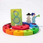 Grimm's 12-Piece Rainbow Birthday Celebration Ring with a celebration heart in the centre and decorative figures for an eighth birthday