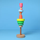 Grimm's Small Conical Stacking Tower - Neon Green - On a plain pink background. Alternative puzzle layout.