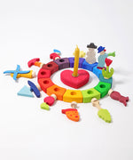 Grimm's 12 Assorted Decorative Figures for celebration rings on a rainbow coloured celebration ring. 