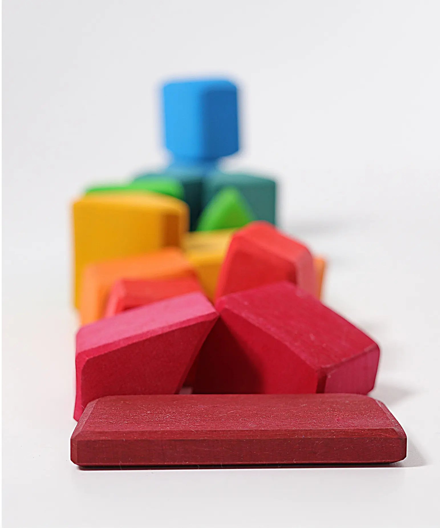 Grimm's 15 rainbow coloured wooden toy building blocks.