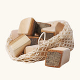 Grimm's 15 wooden blocks with natural bark in a net storage bag.