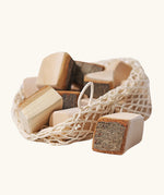 Grimm's 15 wooden blocks with natural bark in a net storage bag.