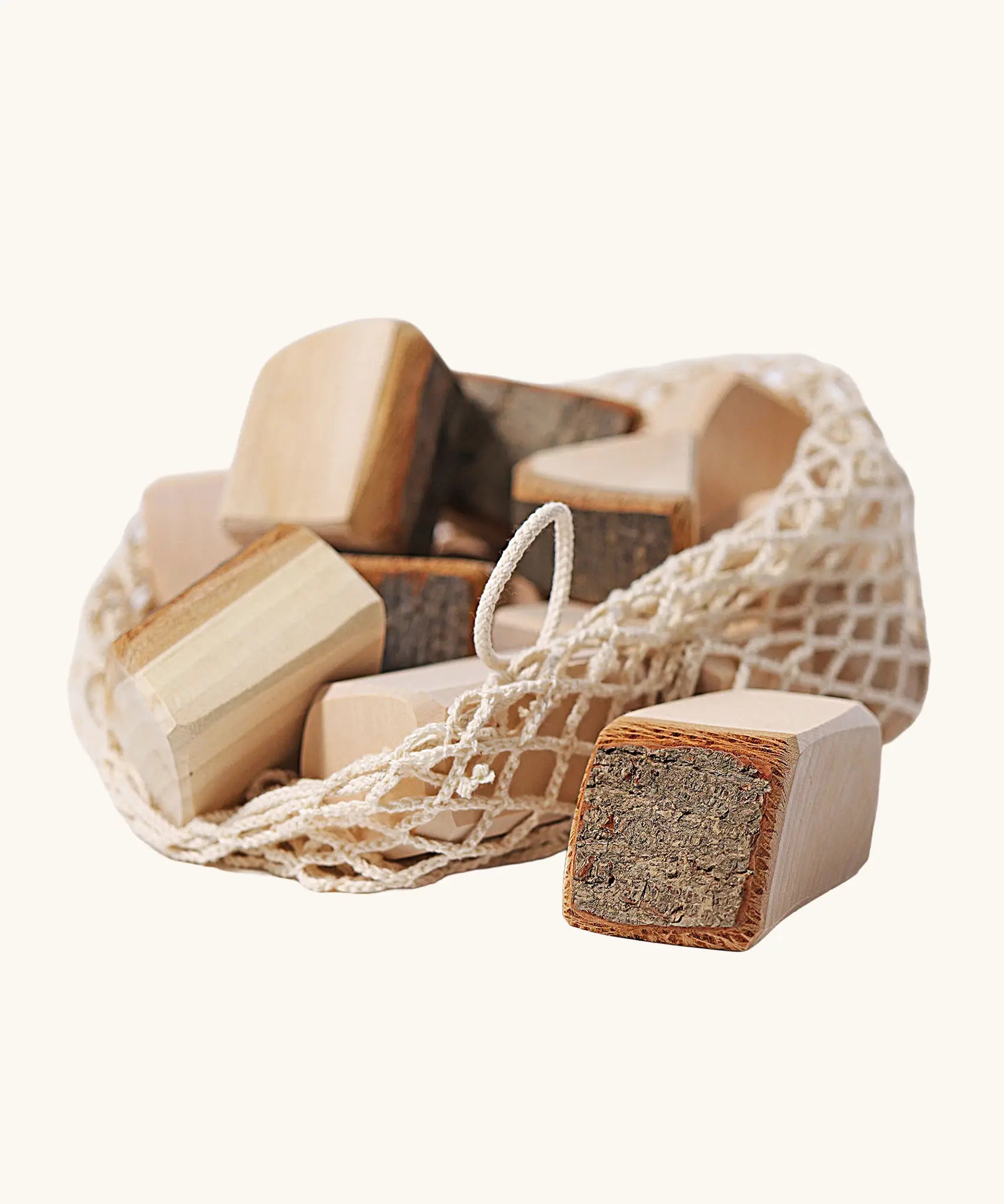 Grimm's 15 wooden blocks with natural bark in a net storage bag.