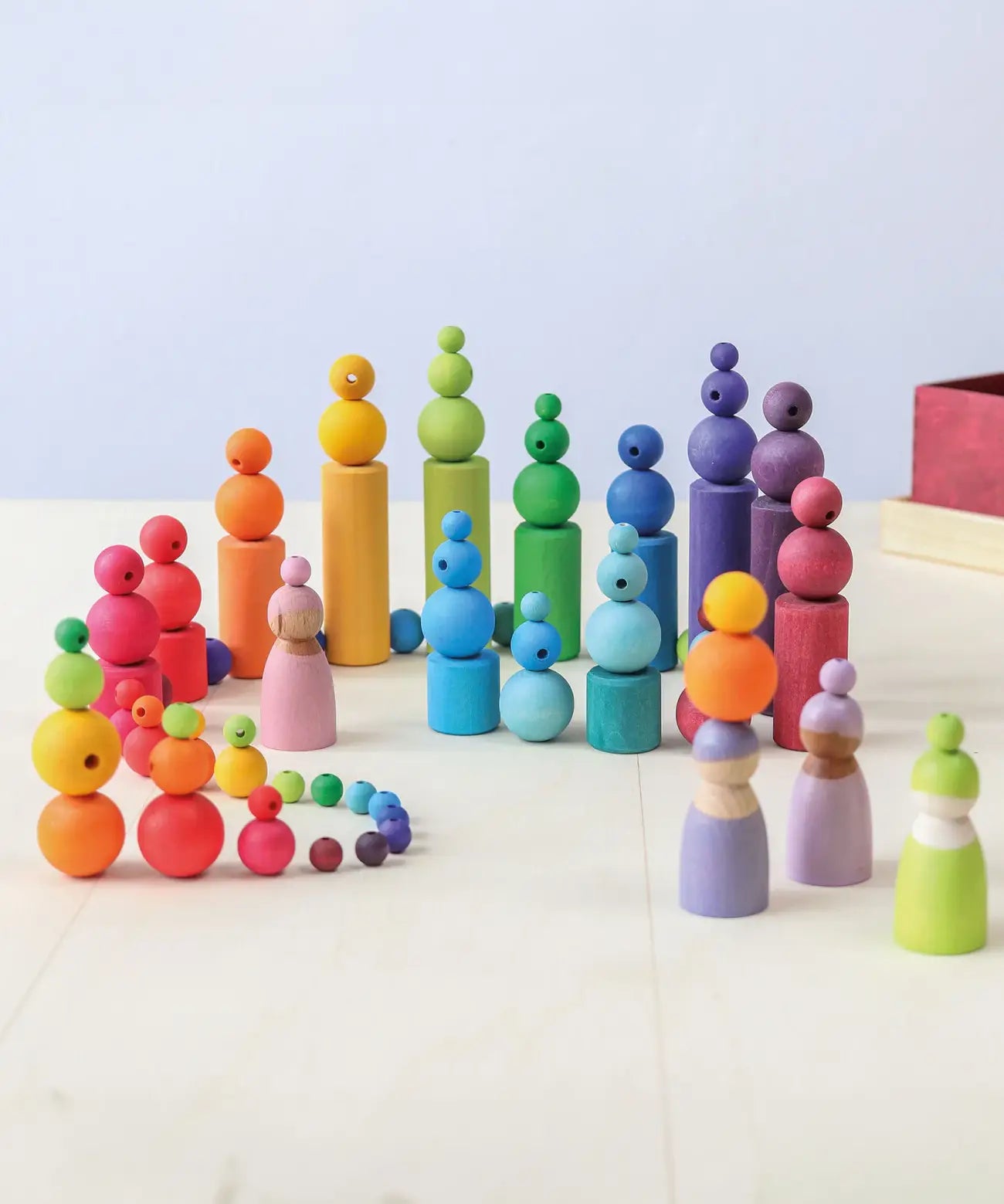 A playscene using Grimms wooden beads, cylinder blocks and peg dolls