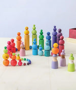 A playscene using Grimms wooden beads, cylinder blocks and peg dolls