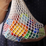 Grimm's 30 Coloured wooden Geo Blocks in their netting storage bag.