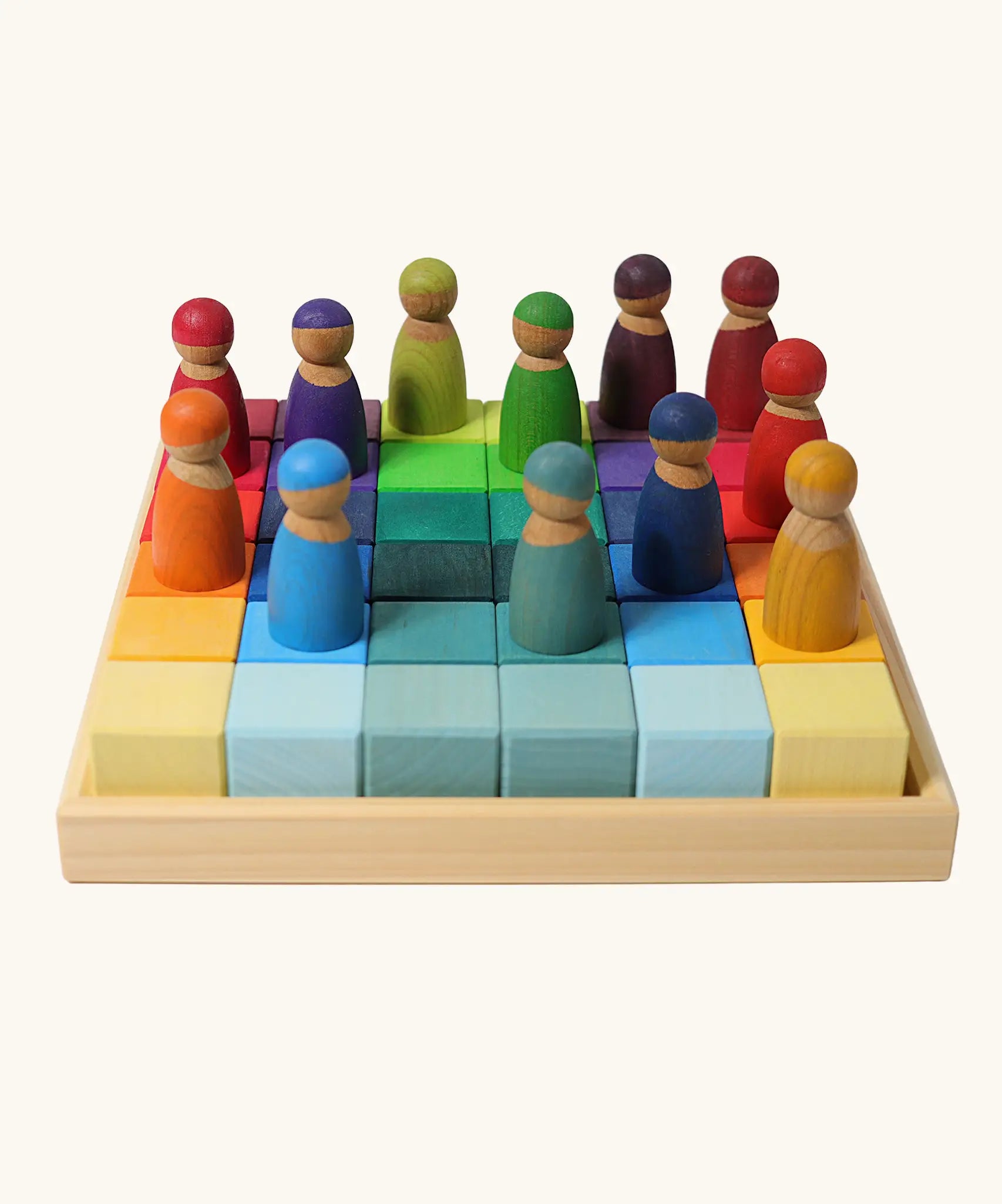 Set of 36 Grimms bright rainbow wooden rainbow cubes in a frame with peg dolls on top