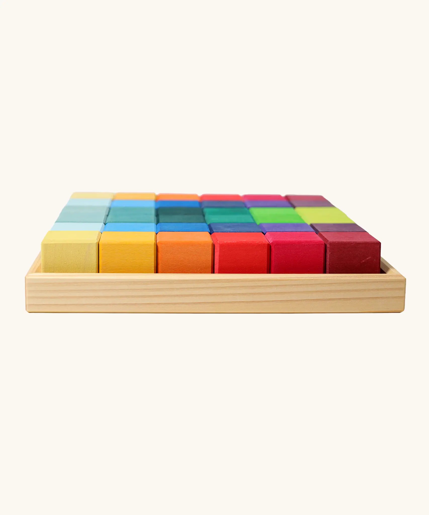 Grimm's 36 rainbow cubes wooden blocks in a storage tray. 