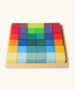 Grimm's 36 rainbow cubes wooden blocks in a storage tray. 