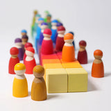 Grimm's 36 rainbow cubes wooden blocks with Grimm's rainbow friends placed on top. 