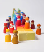 Grimm's 36 rainbow cubes wooden blocks with Grimm's rainbow friends placed on top. 