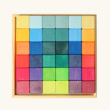 Grimm's 36 rainbow cubes wooden blocks in a storage tray. 