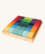 Grimm's 36 rainbow cubes wooden blocks in a storage tray. 