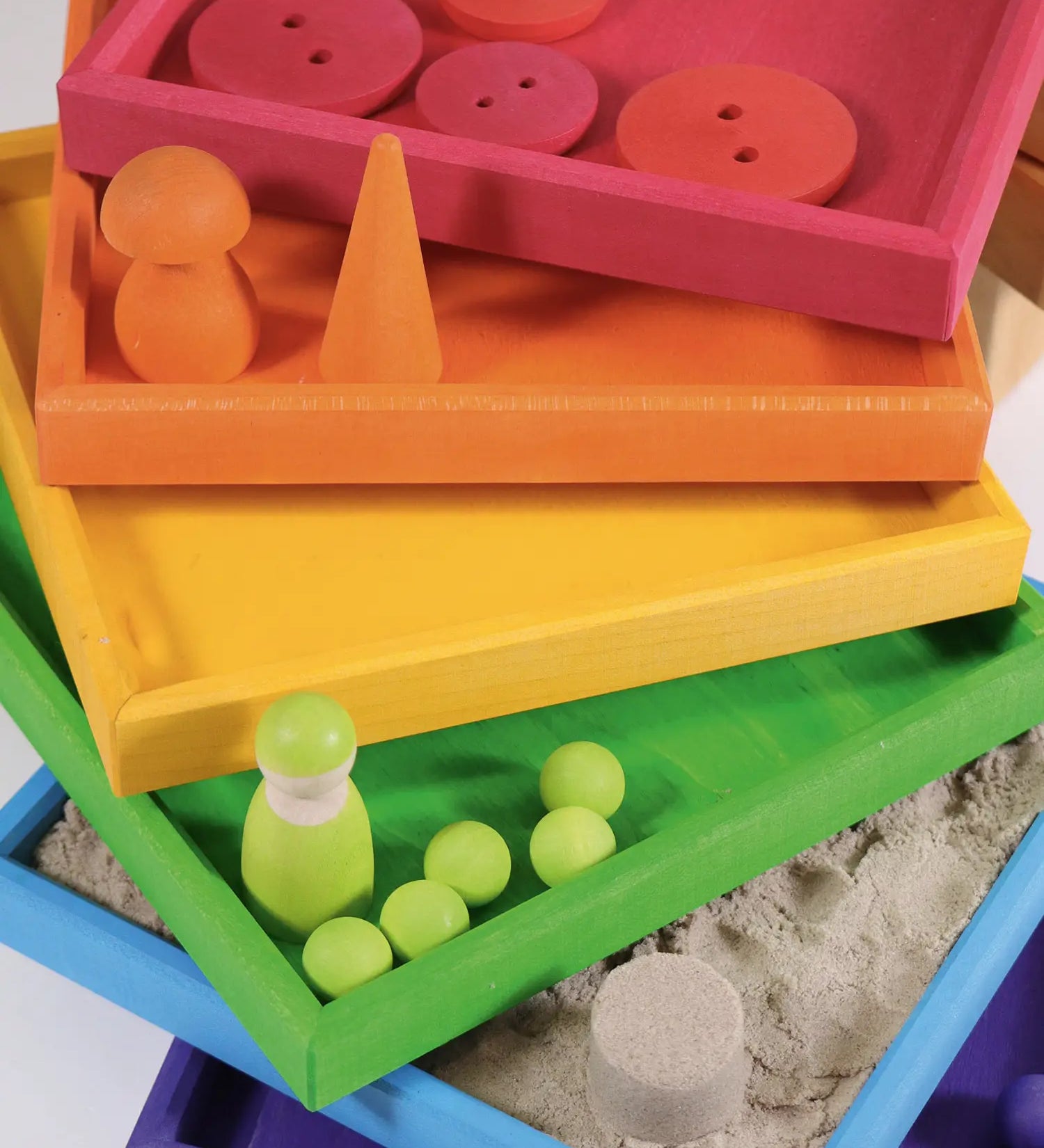 6 handcrafted wooden Grimm's frames in a rainbow palette showing little treasures stored in each frame