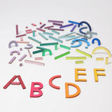 Grimm's alphabet letter shapes. 77 handcrafted wooden pieces in six shapes and 26 colours made for spelling out simple words, numbers and pictures
