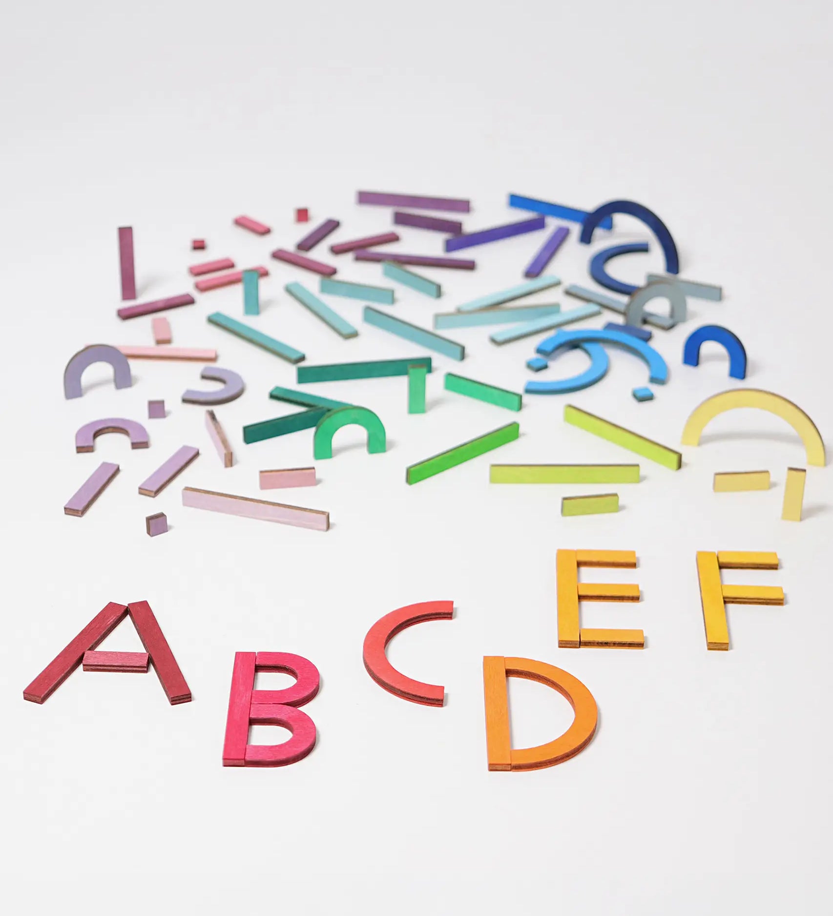Grimm's alphabet letter shapes. 77 handcrafted wooden pieces in six shapes and 26 colours made for spelling out simple words, numbers and pictures