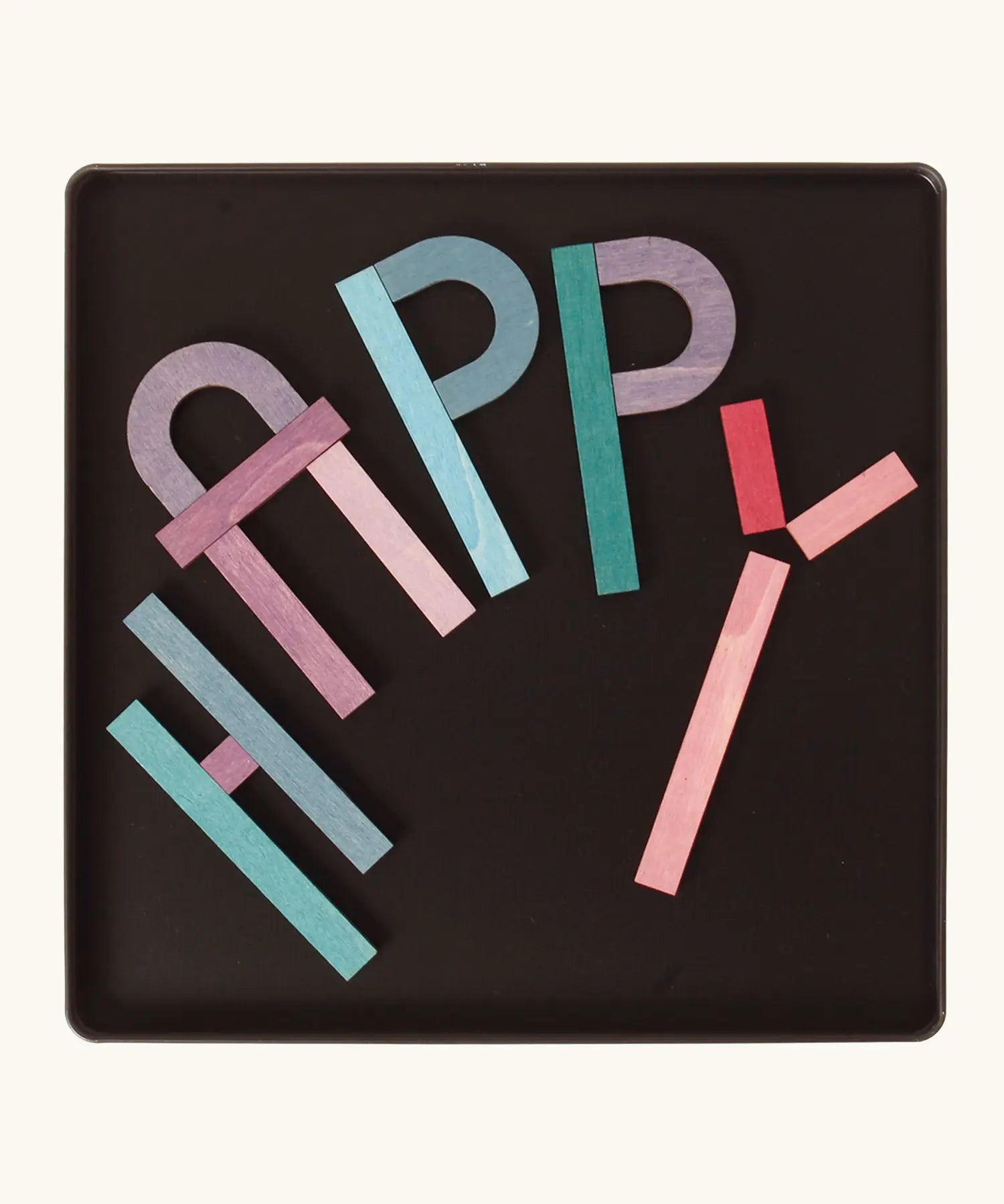 The word 'HAPPY' made from the Grimm's bright wooden A-Z curved and straight magnetic pieces displayed in a tin 
