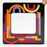 Inside of the tin with the Grimms wooden curved and straight magnetic pieces stuck on