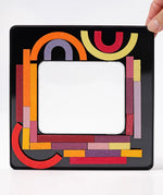 Inside of the tin with the Grimms wooden curved and straight magnetic pieces stuck on