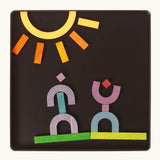 A sunny landscape made from the Grimm's bright wooden A-Z curved and straight magnetic pieces displayed in a tin 
