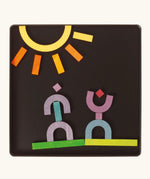 A sunny landscape made from the Grimm's bright wooden A-Z curved and straight magnetic pieces displayed in a tin 
