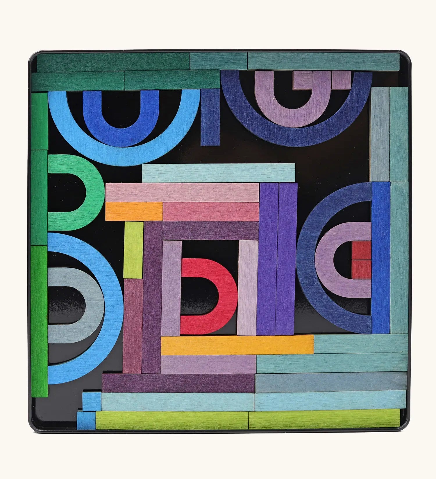 Grimms A-Z magnet puzzle set. Includes 77 curved and straight plywood magnetic pieces in bright colours and a storage tin