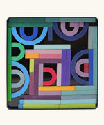 Grimms A-Z magnet puzzle set. Includes 77 curved and straight plywood magnetic pieces in bright colours and a storage tin