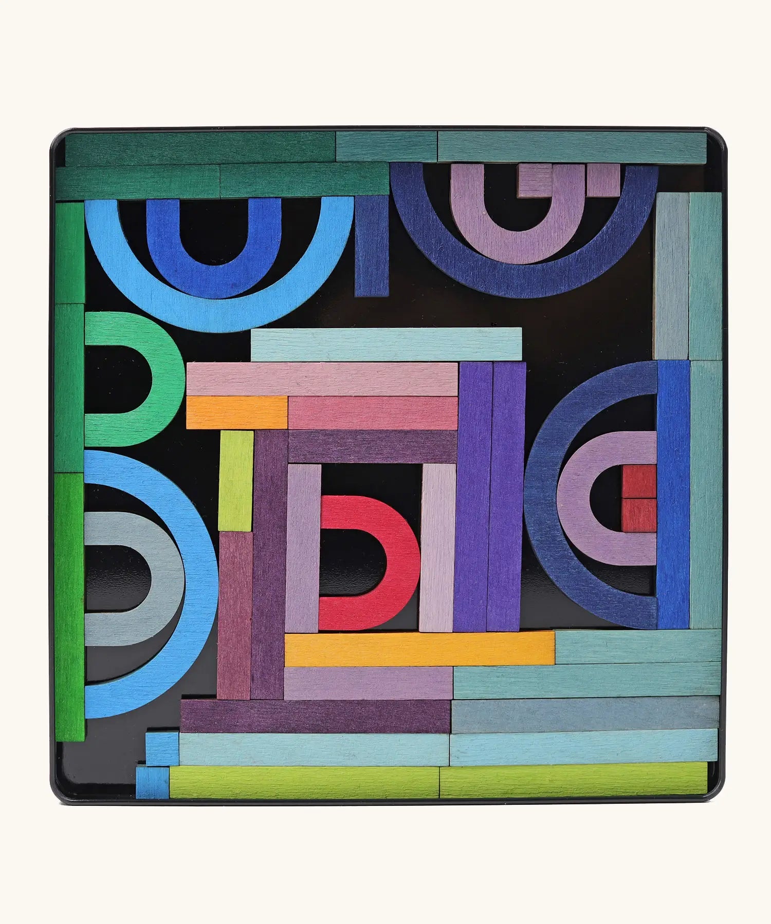 Grimms A-Z magnet puzzle set. Includes 77 curved and straight plywood magnetic pieces in bright colours and a storage tin