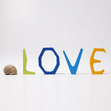 Grimm's Anthroposophical wooden Letters, L, O, V and E. The letters are placed standing up. Perfect for use as educational resources and for adding to seasonal displays. 
