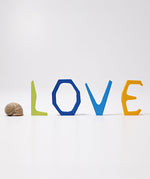 Grimm's Anthroposophical wooden Letters, L, O, V and E. The letters are placed standing up. Perfect for use as educational resources and for adding to seasonal displays. 