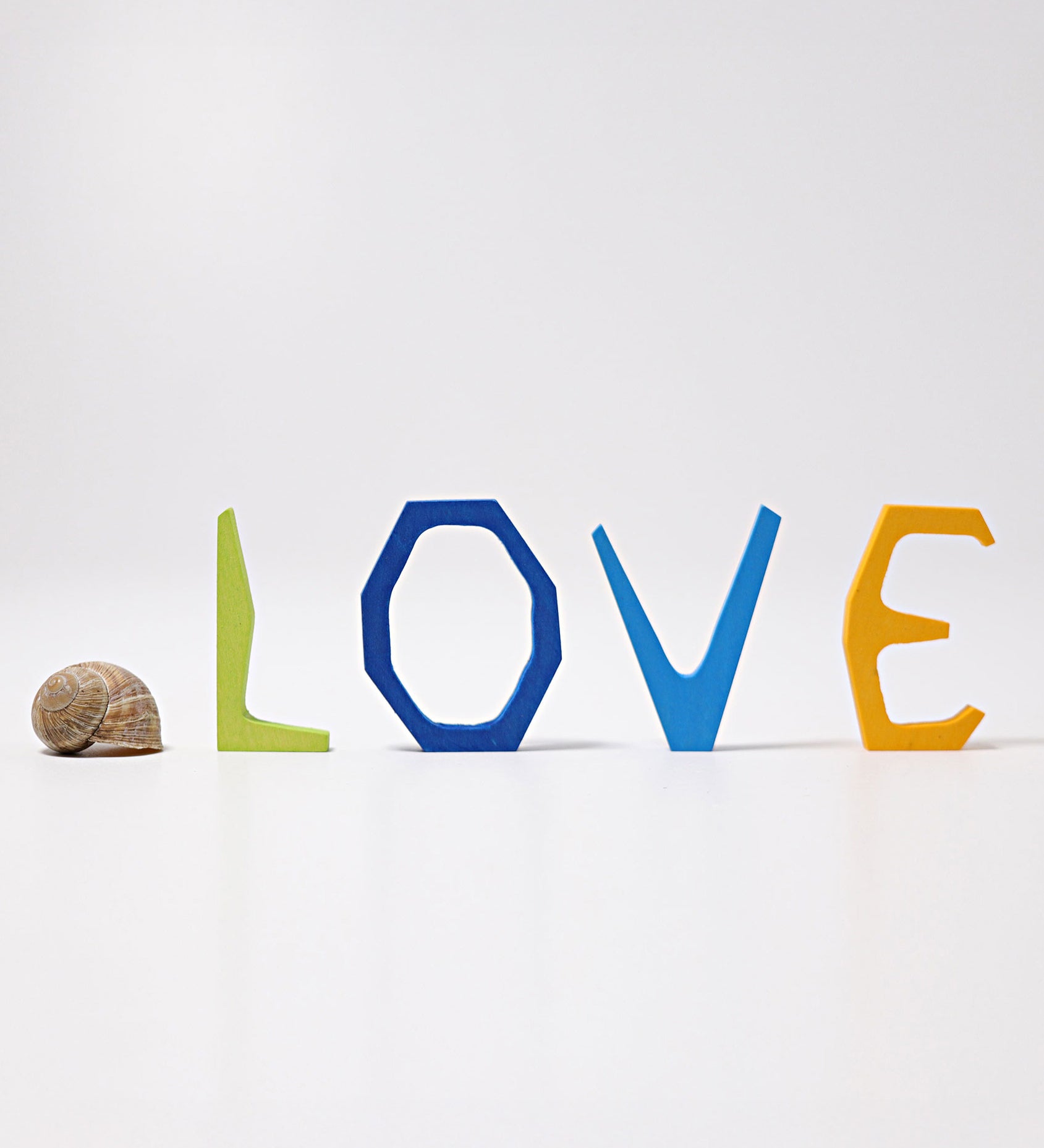 Grimm's Anthroposophical wooden Letters, L, O, V and E. The letters are placed standing up. Perfect for use as educational resources and for adding to seasonal displays. 