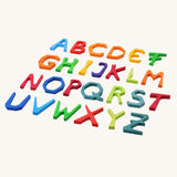 Grimm's Anthroposophical wooden Letters in a rainbow of colours. All 24 wooden letters laid flat. 