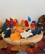 Grimm's wooden celebration ring with Autumn themed decorative figures including a owl, mushroom, dog, tree, pumpkin bat and cat