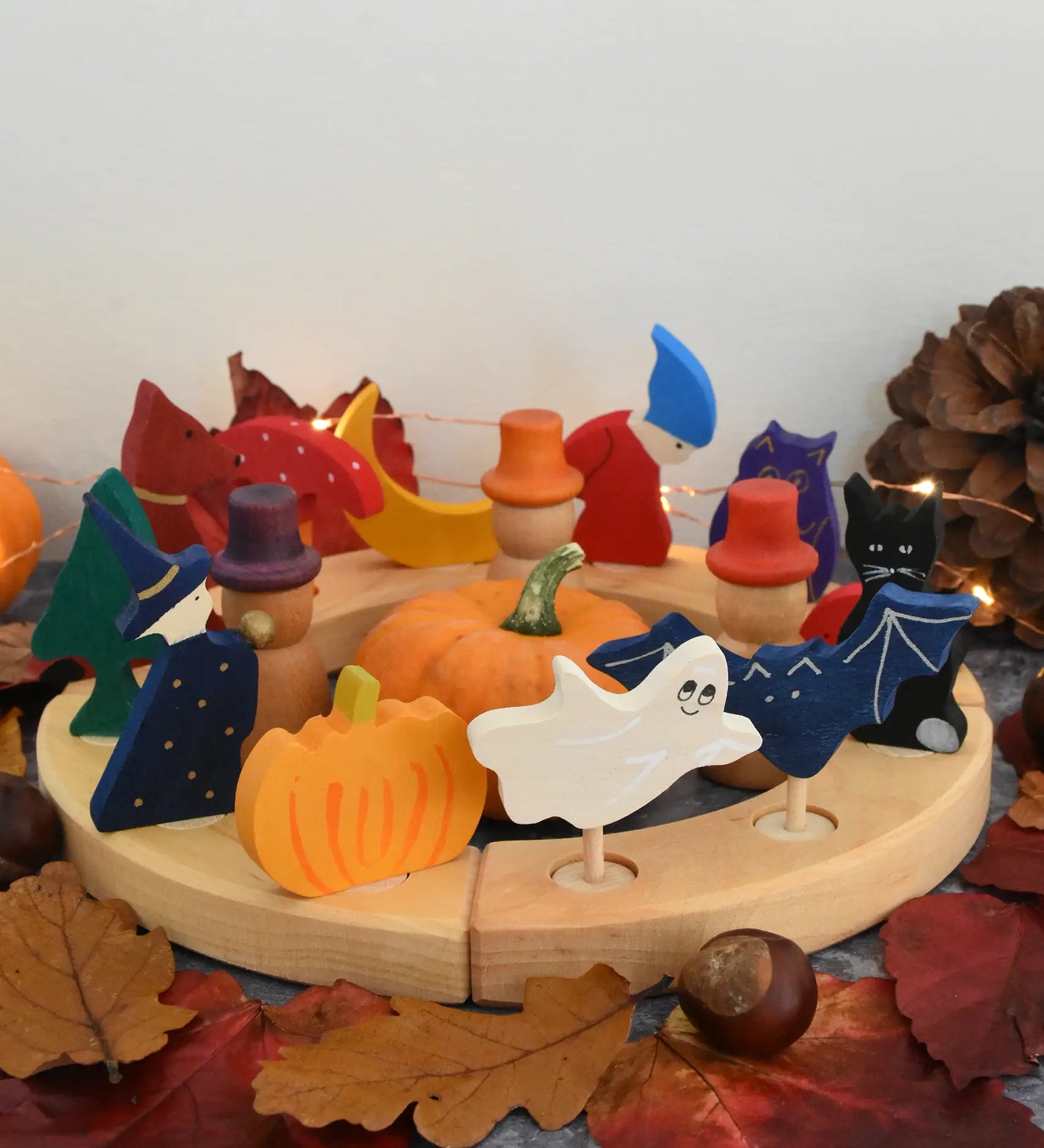 Grimm's wooden celebration ring with Autumn themed decorative figures including a owl, mushroom, dog, tree, pumpkin bat and cat