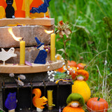 Grimm's Autumn themed display with wooden celebration ring pieces, decorative figures and Ambrosius dolls