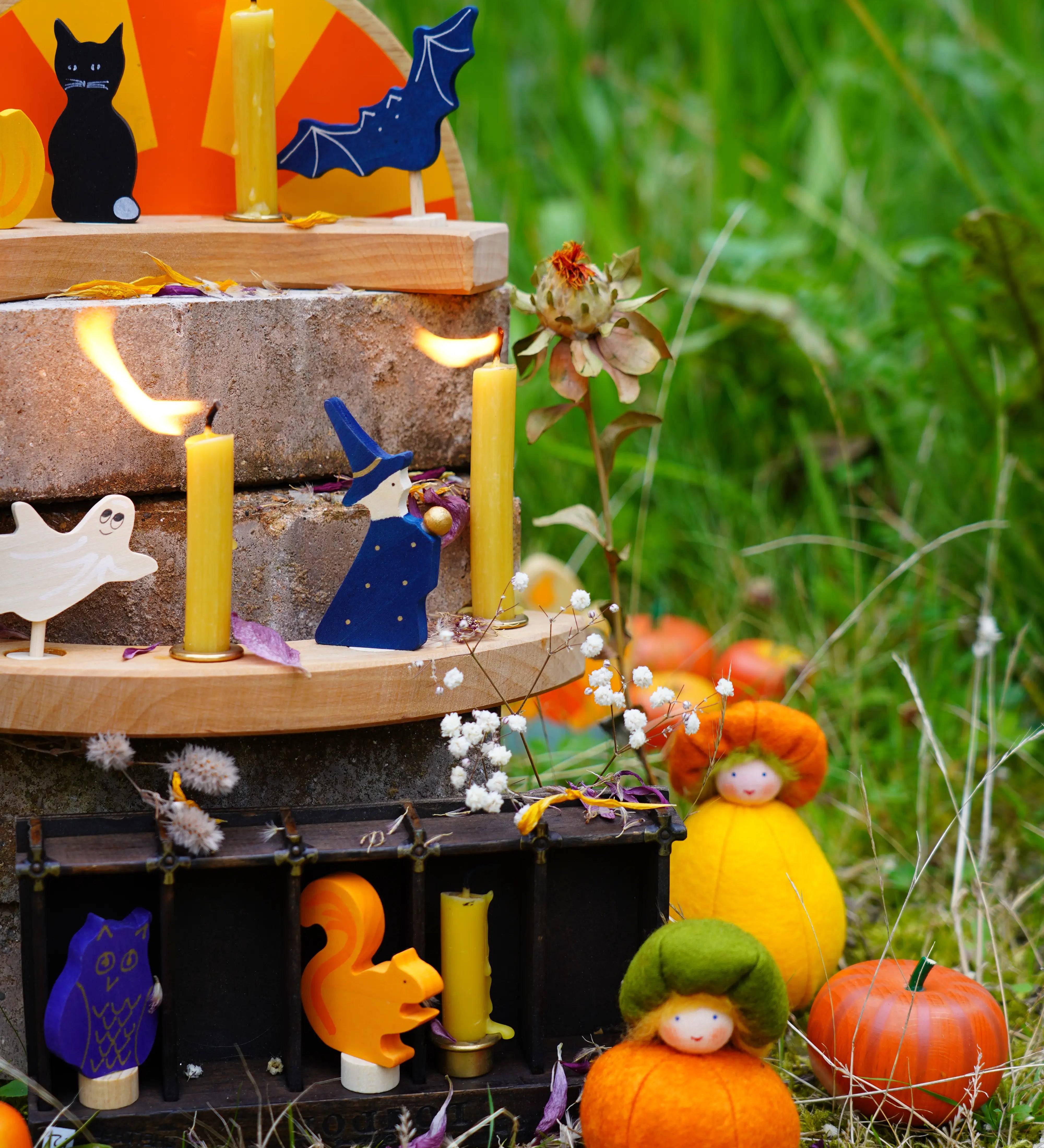 Grimm's Autumn themed display with wooden celebration ring pieces, decorative figures and Ambrosius dolls